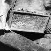 Photographic copy of original image showing plaque at West end of lead coffin from West. (Grave 8)