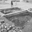 Edinburgh Castle, settlement. Excavation photograph showing area H - S part of first cut, 211 partially removed onto bedrock, cobbling 208/212 in background.