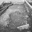 Edinburgh Castle, settlement. Excavation photograph showing area H - completely cleaned cobbling, 211 rough cobbling/ rubble to E.