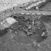 Edinburgh Castle, settlement. Excavation photograph showing area H - pit/trench cuts 221 and undercuts 238 - half sectioned feature.