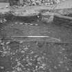 Edinburgh Castle, settlement. Excavation photograph showing area H - ironstone-rich cobbling between 237 and 270.