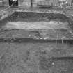 Edinburgh Castle, settlement. Excavation photograph showing area H - group of linear features cutting 265 with 254 wall in background.