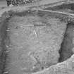 Edinburgh Castle, settlement. Excavation photograph showing area H - cobbling fully exposed with rod on S edge.