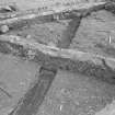 Edinburgh Castle, settlement. Excavation photograph showing area H - cobbling fully exposed with rod on S edge.