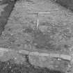 Edinburgh Castle, settlement. Excavation photograph showing area H - cobbling fully exposed with rod on S edge.