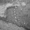 Edinburgh Castle, settlement. Excavation photograph showing area H - modern pit cut through cobbles, containing wood.