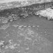 Edinburgh Castle, settlement. Excavation photograph showing area H - N part of cobbling in midden after removal of 257 top midden, and stone layer 255.