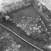 Edinburgh Castle, settlement. Excavation photograph showing area H - S part of cobbling against west baulk.