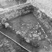 Edinburgh Castle, settlement. Excavation photograph showing area H - S part of cobbling against west baulk.