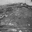 Edinburgh Castle, settlement. Excavation photograph showing area H - SE corner of area, stone revetting?. feature with cobbling 310 to S, and midden 300 to N.