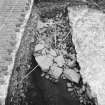 Edinburgh Castle, settlement. Excavation photograph showing area H - NW facing face with rubble (core?) 312 behind.