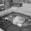 Edinburgh Castle, settlement. Excavation photograph: area H - cobbles and fully excavated wall 254 showing cobbles cut by wall trench, from W.