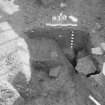 Edinburgh Castle, settlement. Excavation photograph: area H - half section through pit with 416 iron-rich feature partially exposed.