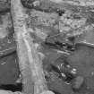 Edinburgh Castle, settlement. Excavation photograph: area H - half sectioned red clay floor 366 revealing 432 cut.