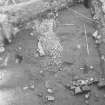 Edinburgh Castle, settlement. Excavation photograph: area H - cobbling on bedrock in N part of area, wall (?) 442 to N.