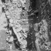 Edinburgh Castle, settlement. Excavation photograph: area H - cobble spread running under jumble of stones 529 and earlier causeway 450.