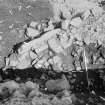 Edinburgh Castle, settlement. Excavation photograph: area H - detail of jumble of stones including quern - under causeway.