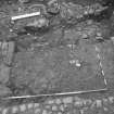 Edinburgh Castle, settlement. Excavation photograph : area H - metalled brown surface between walls down to low defence.