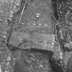 Edinburgh Castle, settlement. Excavation photograph : area H - metalled brown surface between walls down to low defence.