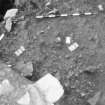 Edinburgh Castle, settlement. Excavation photograph : area H - cobbling of very small stones below 535 with burnt area/hearth 592 to west, from north-east.