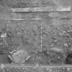 Edinburgh Castle. Excavation photograph : area H - shattered slabs 1223, cobbles 551, from west edge of trench.