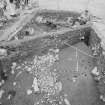 Edinburgh Castle, settlement. Excavation photograph: area H - stakehole line cutting 433, clay layer on W side of cobbling.