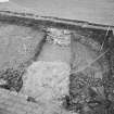 Edinburgh Castle. Excavation photograph : area H - Charles II wall after being cut showing rubble to north of cobbling.