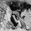 Edinburgh Castle. Excavation photograph : area H - detail of rock cut pit with architectural stonework in lower fill, looking south.