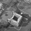 Oblique aerial view of Holyrood Palace and Abbey, Edinburgh, with fountain also visible.