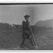 Copy of a historic photographic view of a boy digging with 'caschrom', entitled 'ploughing'.  From the Banff Album.