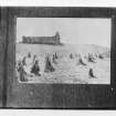 Copy of a historic photographic view of St Donnan's Church, Kildonnan, with hay bales in the foreground. Taken from The Banff Album.