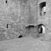 View of withdrawing room showing remains of doorways into original tower house, Crichton Castle.
