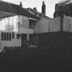 Excavation photograph: location shot
General view from S showing partially demolished building

