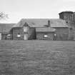 General view of ruinous tower and adjoining building.