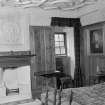 Interior view of Craigievar Castle showing first bedroom with fireplace.