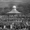 View of the Ross Bandstand, Princes Street Gardens, Edinburgh, showing orchestra and spectators.
