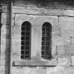 Detail of pair of arched leaded windows on first floor.
