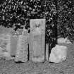 Churchyard, a small stone decorated with a robed figure, and fragments of two hog-backed stones