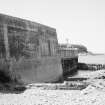 View of sea wall, rocky foreshore and sea.