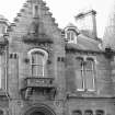 Detail of crow stepped gable, turret, balcony and windows on main elevation.