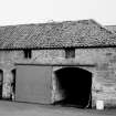 View of barn with flat arched entrances and pantiled roof