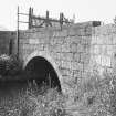 View of W bridge from SE, showing masonry arch.
