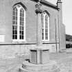 General view showing war memorial adjacent to church.