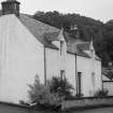 Oblique view of unidentified white harled 2-storey cottage