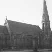 General view of gate piers and St Peters from N.