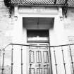 Spylaw House, Bridge Road, Colinton.
View of main North entrance doorway, showing moulded lintel, iron balcony at first floor level, and iron balustrade to front curved double stair.