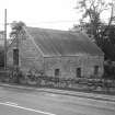 View of outbuilding from NE.