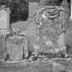 Glendevon Parish Church, Churchyard.
General view of two tombstones. The first with a winged soul, the second with a carved stone 'drape' over the top.