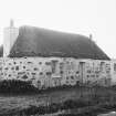General view of thatched cottage.