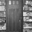 Interior view of 1 Dunira Street, Comrie, showing panelling in counter in the shop of Brough and Macpherson.